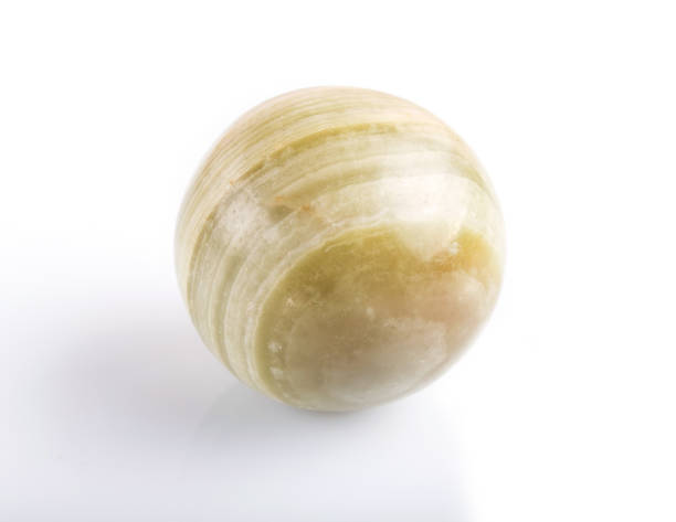 istock green onyx sphere isolated on white background, close up. 1198587355