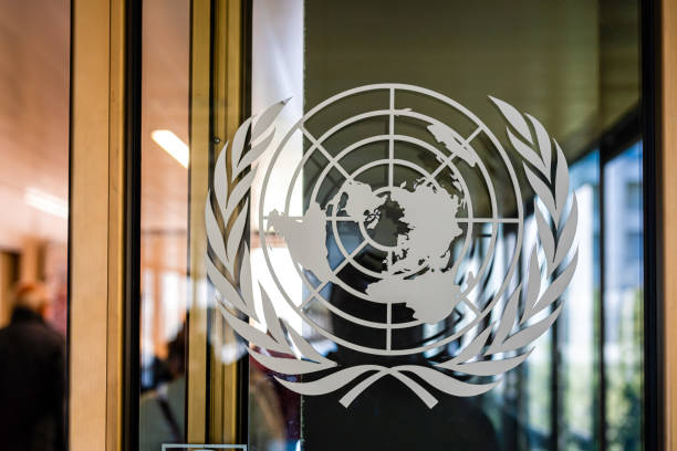 The United Nations sign on the entrance door of the Palace of the Nations Geneva, Switzerland - April 15, 2019: The United Nations sign on the entrance door of the Palace of the Nations - image united nations stock pictures, royalty-free photos & images