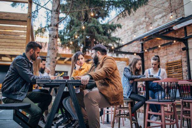 istock Group of young joyful friends having fun in a pub 1198589240