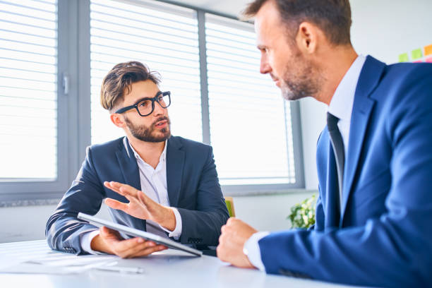 istock Two businessmen discussing in office 1198589266