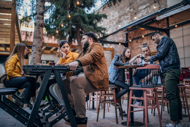 istock Group of young joyful friends having fun in a pub 1198589278