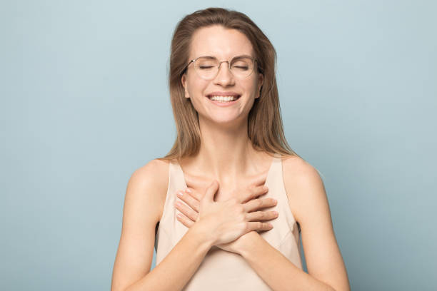 istock Happy young woman keep hands at chest feeling grateful 1198590470