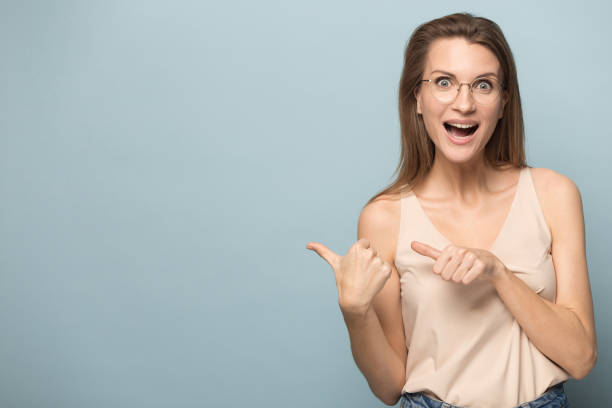 istock Excited millennial woman point at blank copy space 1198590495