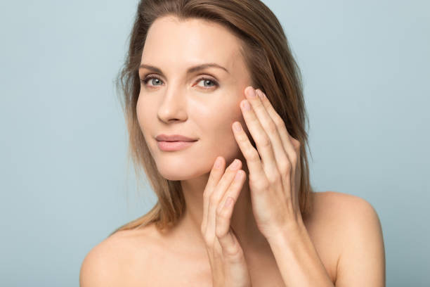 Millennial Caucasian woman touch soft healthy skin Millennial Caucasian woman touch soft healthy skin