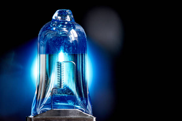 istock Spare light bulb for a car's headlights on black background. Copy space. 1198590838