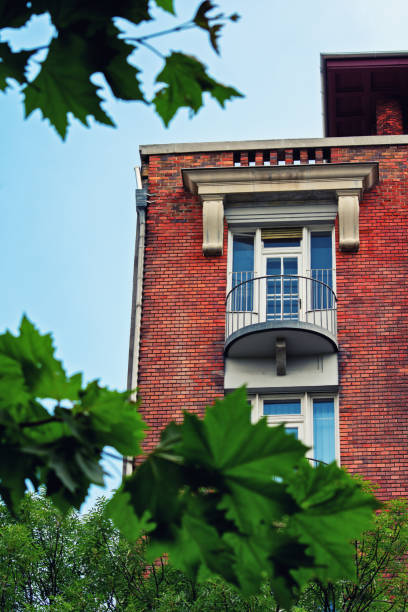 istock Low angle view of a balcony on a red brick building 1198591095