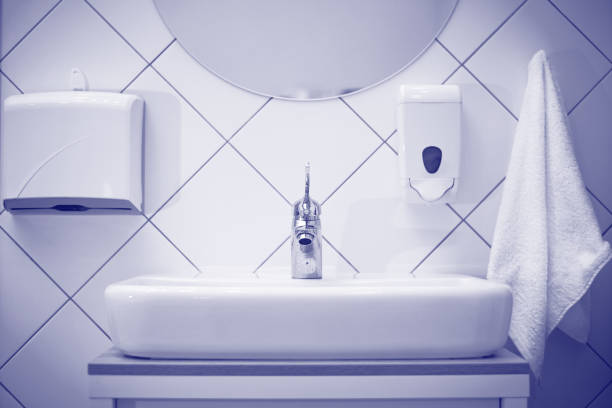 White sink with a towel and soap in spa salon.