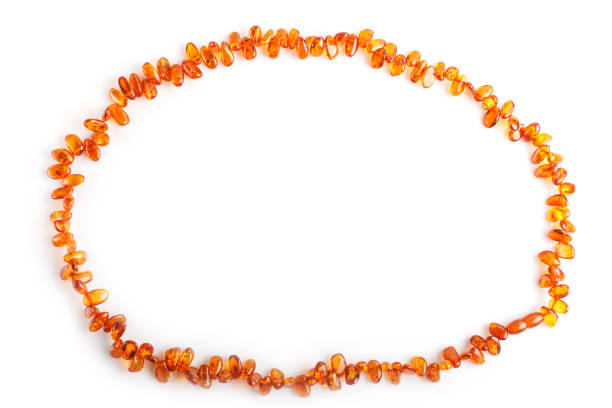 istock orange amber beads isolated on white background. top view, close up. 1198592151
