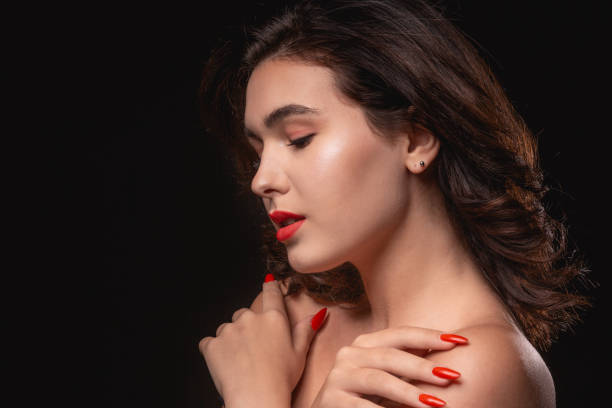 istock Beautiful woman with bright makeup posing isolated over black background. 1198592163