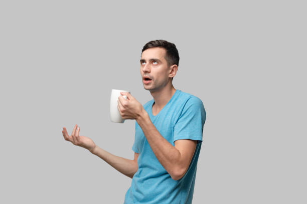 istock Young brunet man drinking coffee form enjoying its aroma. 1198592200