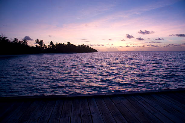 Maldives - May 3, 2025:  A beautiful view from Amber, a Champagne bar, of Waldorf Astoria Maldives Ithaafushi luxury resort during blue hour after sunset.  HDR encoded