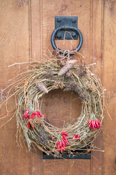 istock Red Peppers on Christmas Wreath with Wood 1198594065