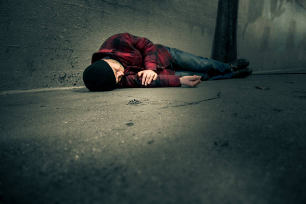 istock Homeless young man sleeping rough in cold subway tunnel 1198594311