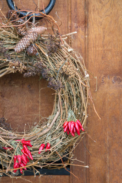 istock Red Peppers and Cone on Christmas Wreath 1198594394