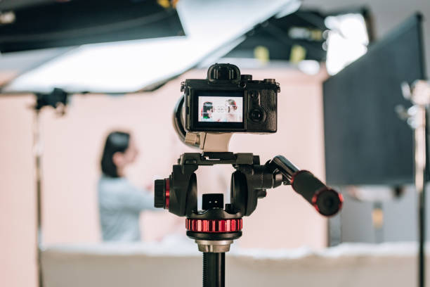 istock Selective focus of female model and assistant reflecting in camera display in photo studio 1198596864