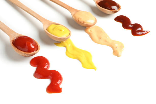 istock Wooden spoons with sauces isolated on white background 1198598059