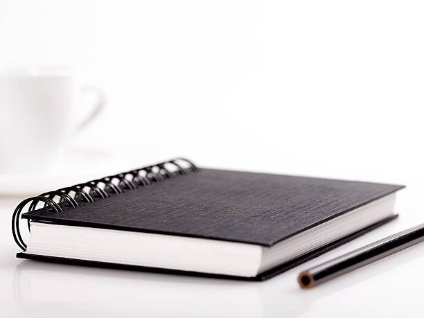 artist's sketch book, pencil and coffee cup on white stock photo