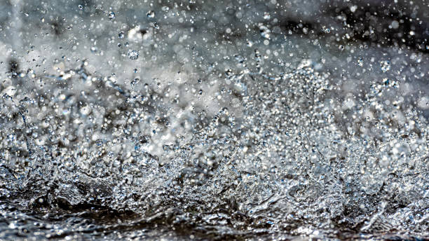 istock Water splash with small drops in the fountain. Abstract natural, selective focus  background 1198599996