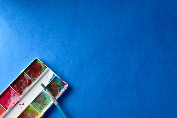 istock brush and water color paint at blue background with copy space 1198600076