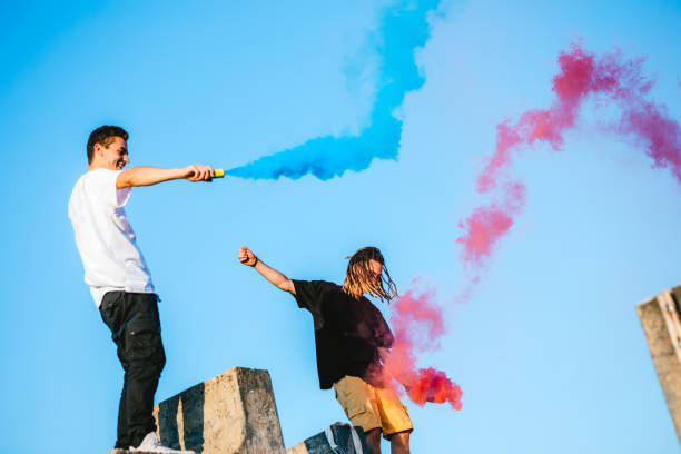 istock Releasing a colored smoke bomb on rooftop 1198600359