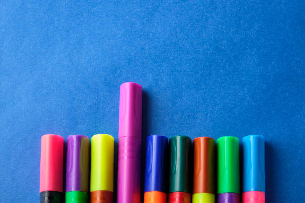 istock Multi colored felt pens with wrong color caps at blue background 1198602666