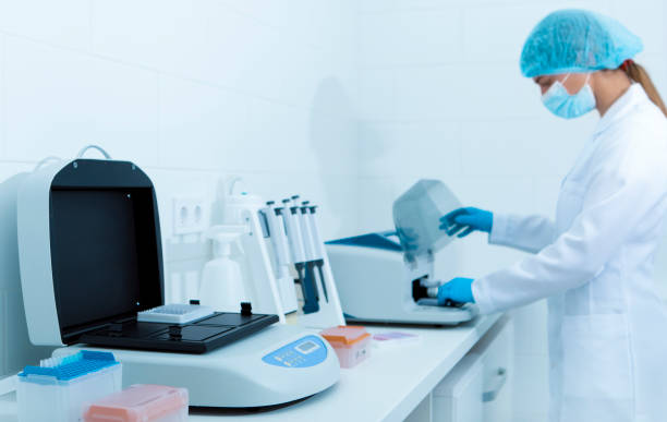 istock Young female lab assistant making copy of analysis results 1198604186