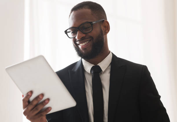 istock Young successful businessman making marketing research on tablet 1198604283