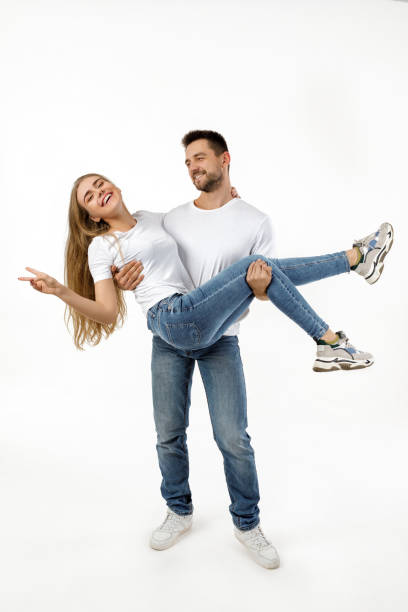 istock man holding girlfriend on his arms 1198604391