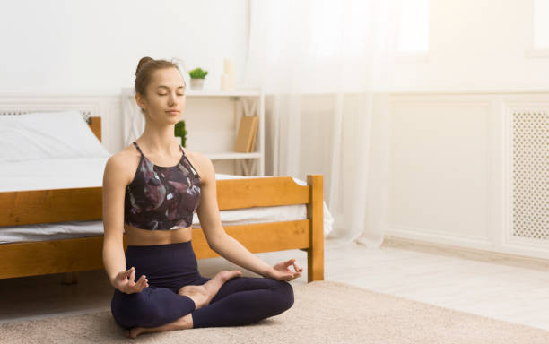 istock Morning routine. Calm woman enjoying yoga training 1198604745