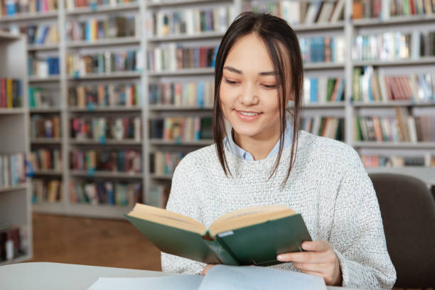 istock Attractive female student studying at the library 1198605924
