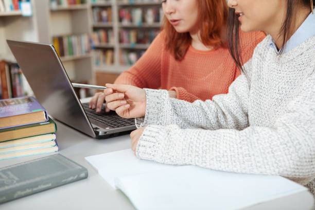 istock Female friends studying at the library 1198606059