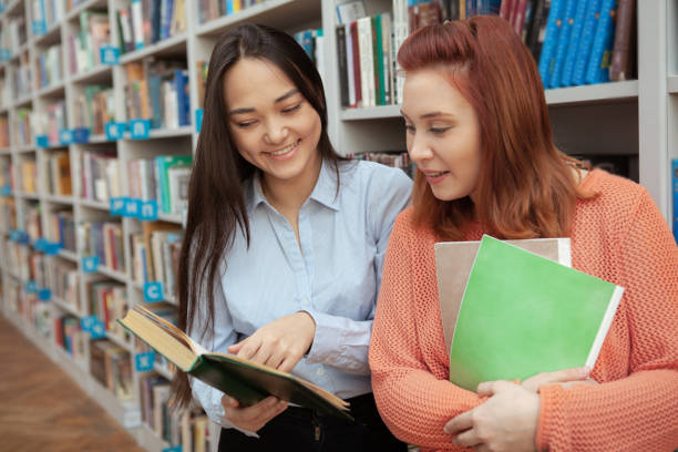 istock Female friends studying at the library 1198606735