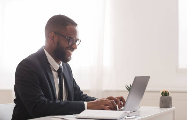 istock Black businessman working in modern high tech office 1198607072