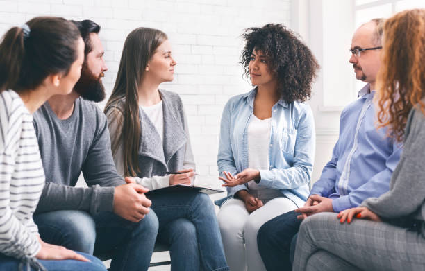 istock Glad patients talking with professional therapist, panorama 1198607874