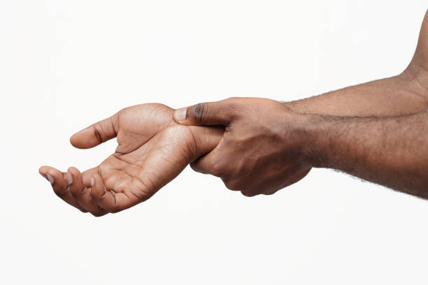 Carpal tunnel pain. Man massaging painful wrist Carpal tunnel pain. Black guy massaging painful wrist, close up wrist stock pictures, royalty-free photos & images