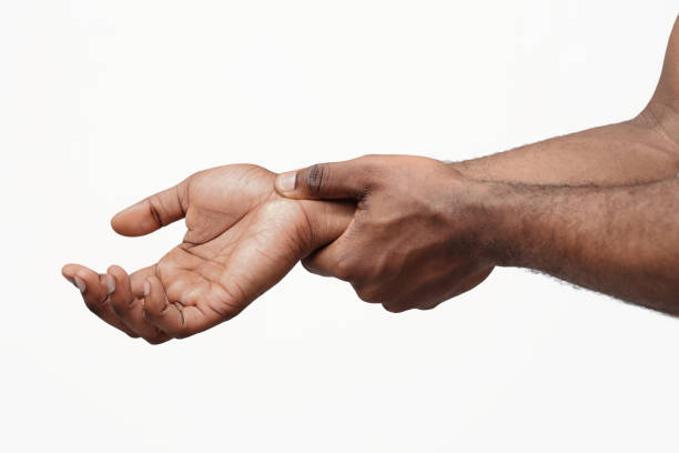 Carpal tunnel pain. Man massaging painful wrist Carpal tunnel pain. Black guy massaging painful wrist, close up Wrist stock pictures, royalty-free photos & images