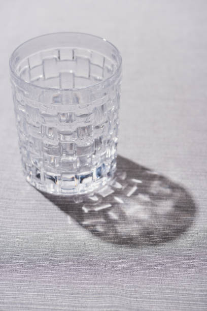 istock Clear textured glass with shadow on grey cloth 1198609445