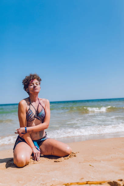 istock Woman with body paint on the beach 1198610781