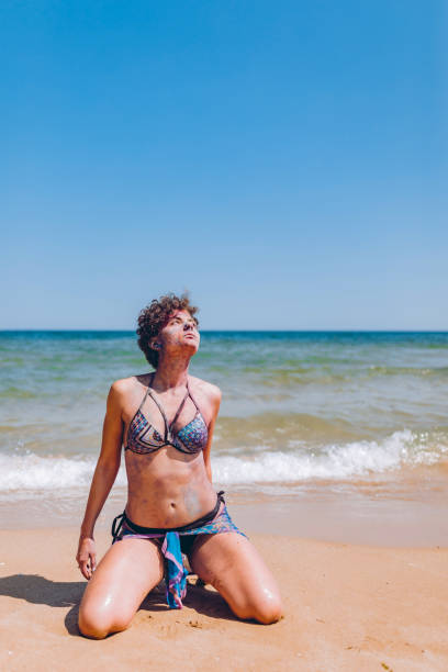 istock Woman with body paint on the beach 1198611205
