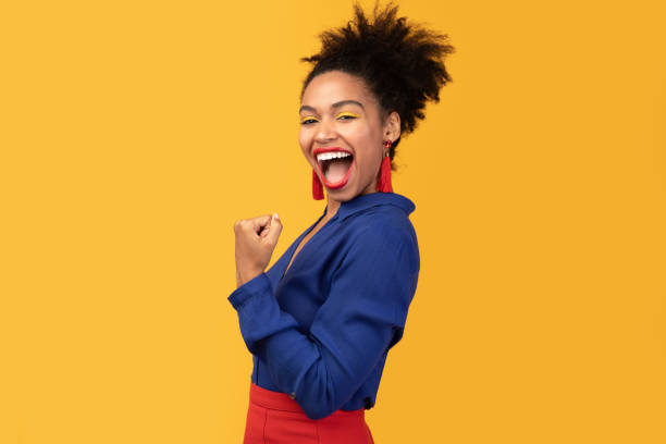 istock Happy afro woman triumphing with raised hands 1198614645