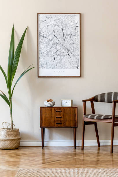 istock Modern composition of living room interior with brown mock up poster frame, design retro commode, chair, rattan basket with palm plant and elegant accessories. Template. Stylish home staging. Japandi. 1198615444