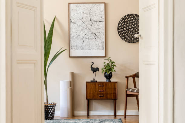 istock Modern scandinavian living room interior with brown mock up poster frame, design retro commode, chair, rattan decor, carpet, plants and elegant accessories. Template. Stylish home staging. Japandi. 1198615469