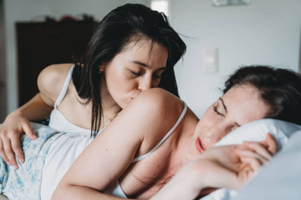 istock Young adult couple waking up together 1198615516