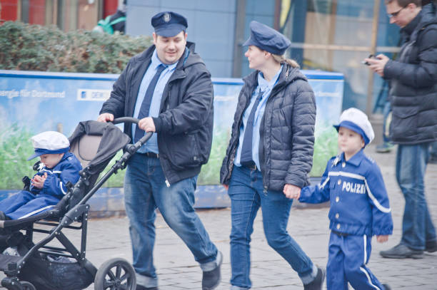 Young family dressed as German cops at 2019 Dortmunder Rosenmontag (Rose Monday Carnival) in Germany.