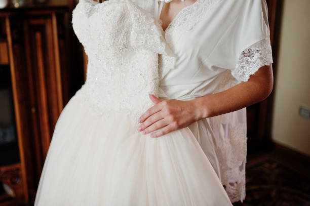 istock Elegant white wedding dress at bride morning on hands. 1198616263