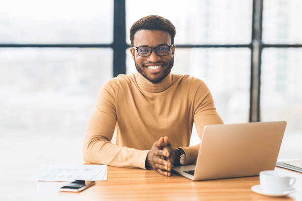 istock Smiling black businessman working at modern office 1198616620