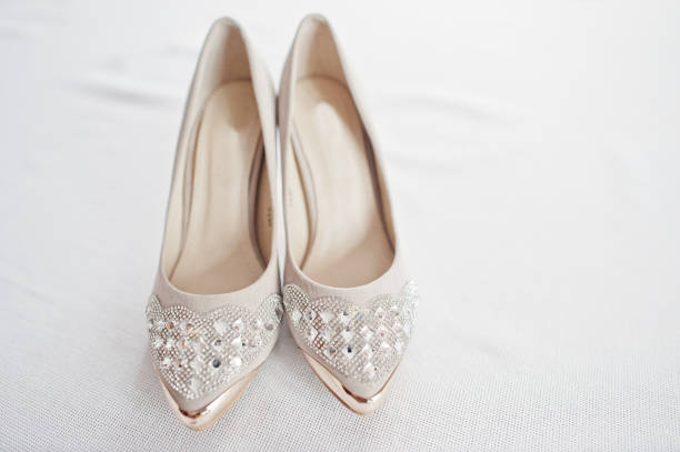 Elegant white wedding shoes at bride morning.