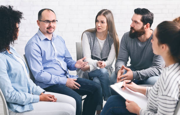 istock Group of patients talking at therapy session 1198618519