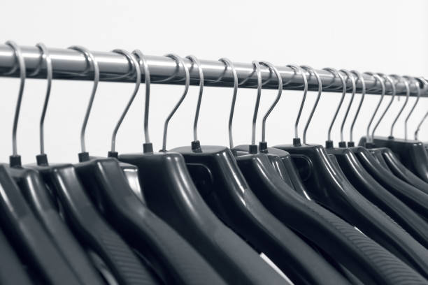 istock Empty plastic hangers hanging in a wardrobe for clothes 1198618670