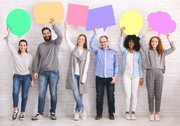 istock Diverse people holding colorful speech bubbles, free space 1198620758